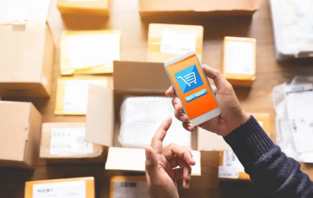 Online shopping concepts with youngman using smartphone for payment his order on a lot of product package box.Ecommerce market.Business retail.modern life.