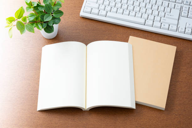 istock Notebook and keyboard on wooden desk. 1176174169