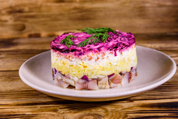 istock Ceramic plate with russian traditional new year salad herring under fur coat (shuba) and on rustic wooden table 1176177846