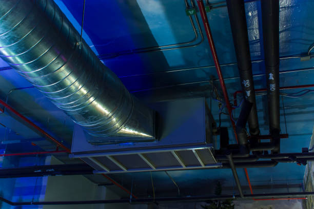 istock HVAC Duct Cleaning, Ventilation pipes in silver insulation material hanging from the ceiling inside new building. 1176178138