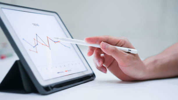 close up salesman employee hand using stylus pen to pointing on tablet screen to show statistic graph of company profit monthly in the meeting event at conference room , business strategy concept close up salesman employee hand using stylus pen to pointing on tablet screen to show statistic graph of company profit monthly in the meeting event at conference room , business strategy concept shareholder photos stock pictures, royalty-free photos & images