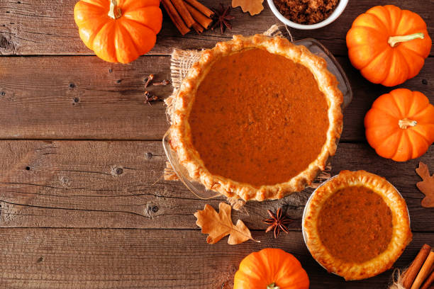istock Homemade autumn pumpkin pie, top view corner border over a rustic wood background 1176181270