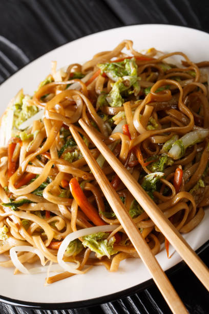 istock Authentic steer fried from chow mein noodles with vegetables close-up on a plate. vertical 1176181296