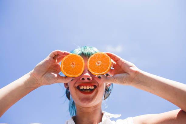 istock Cheerful young woman with orange 1176184253