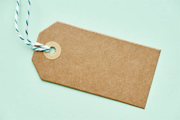 Blank brown gift tag with twine on green