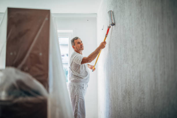 istock Senior painter painting walls in white 1176184677