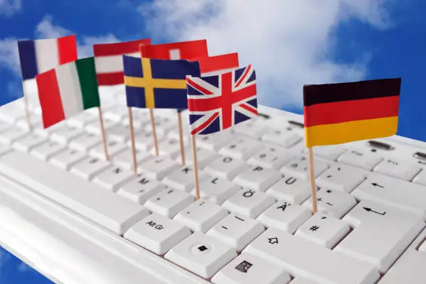 Photo of Keyboard with european flags and sky as background