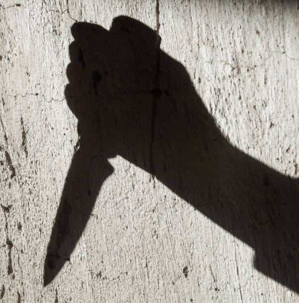 istock Shadow of the hand holding a knife 1176188484