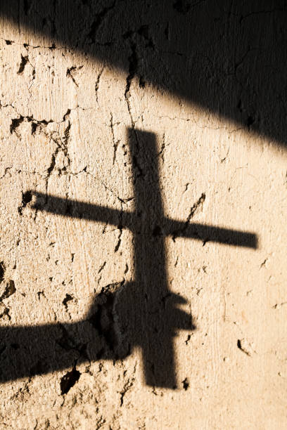 istock Shadow of the hand holding a cross 1176188490