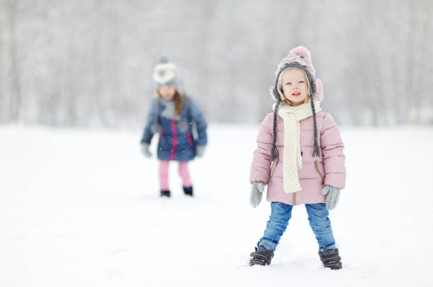 istock Two funny adorable little sisters winter park 1176189166
