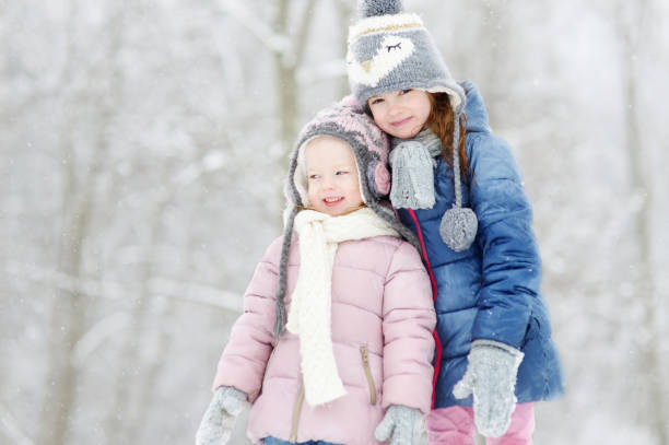 istock Two funny adorable little sisters winter park 1176189181