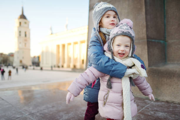 istock Two funny adorable little sisters outdoors in winter 1176189201
