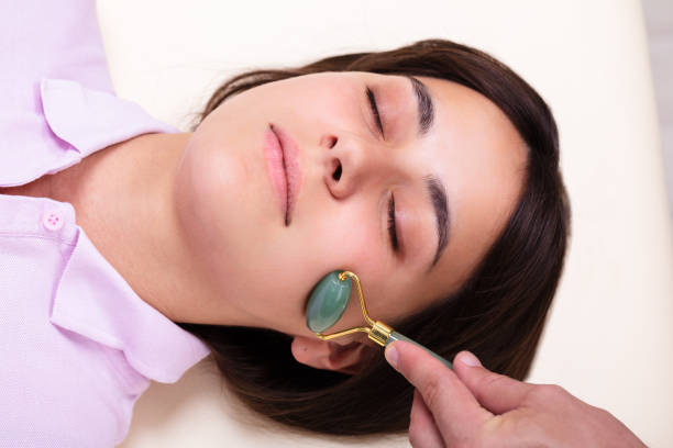 istock Woman Receiving Gua Sha Facial Massage Tools From Jade Roller 1176189492