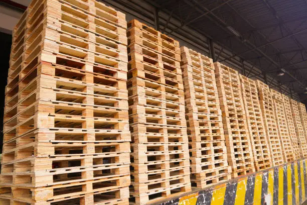 Wooden pallets stack at the freight cargo warehouse for transportation and logistics industrial