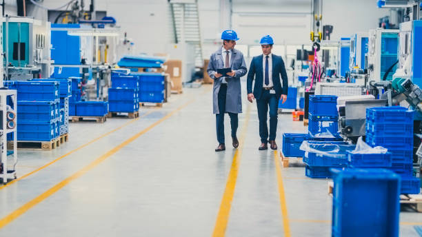 istock Engineer showing automated factory to company CEO 1176197932