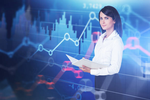 istock Smiling woman trader and digital graphs 1176198667