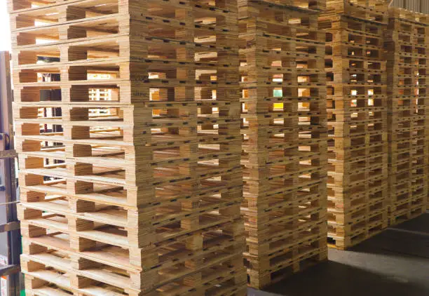 Wooden pallets stack at the freight cargo warehouse for transportation and logistics industrial