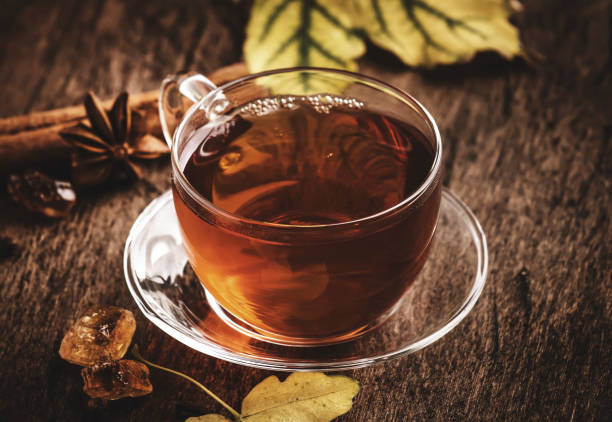 istock Autumn hot black tea in glass cup, old wooden table background, selective focus 1176199641
