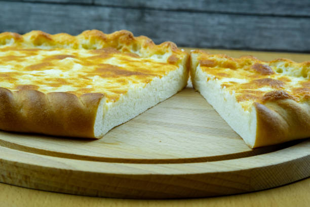 istock Freshly baked khachapuri with cheese on a wooden board. 1176200190