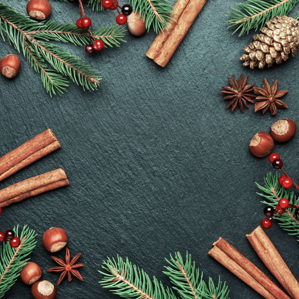 istock Christmas or New Year dark background, frame, template, with festive decorations, winter spices and Christmas decorations, nuts and fir branches, top view 1176200393