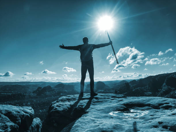istock Tourist boy with backpack and sticks in foggy mountain range 1176201630