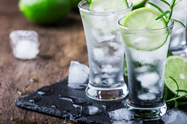 istock Classic gin tonic cocktail with lime, ice and rosemary. Vintage bar, bar tools. With copy space 1176202357