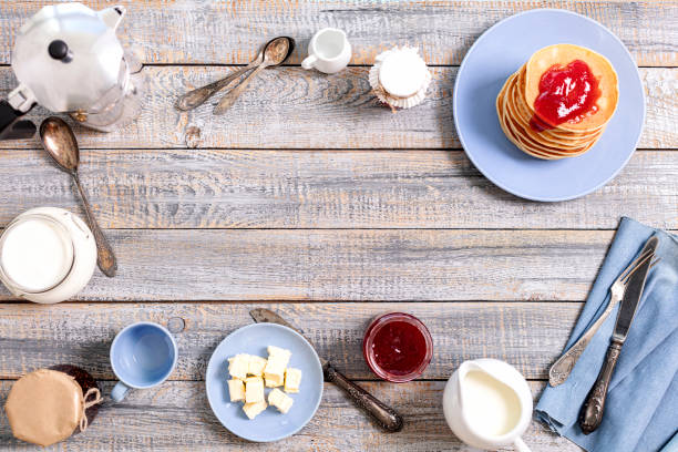 Tasty breakfast. Pancakes with strawberry confiture and butter. Selective focus.
