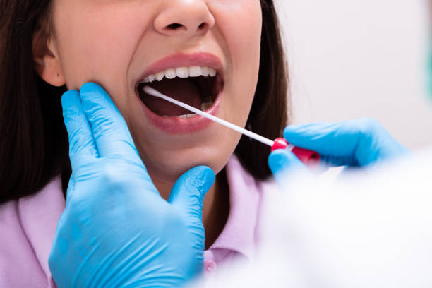 Close-up Of A Doctor Taking Saliva Sample For DNA Test Rear View Of A Male Doctor Taking A Bodily Fluid Sample For DNA Test cotton swab stock pictures, royalty-free photos & images