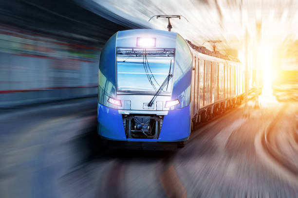 istock Passenger train passes station in urban landscape. 1176208466