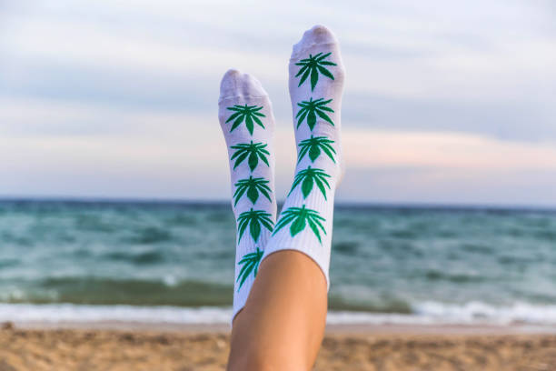 Woman on beach with marijuana socks