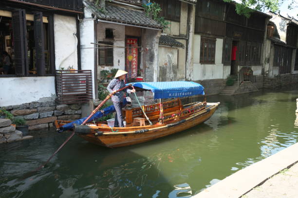 Boats in Zhouzhuang passing through canal Zhouzhuang,China-September 17, 2019: Boats in Zhouzhuang passing through canal suzhou creek stock pictures, royalty-free photos & images