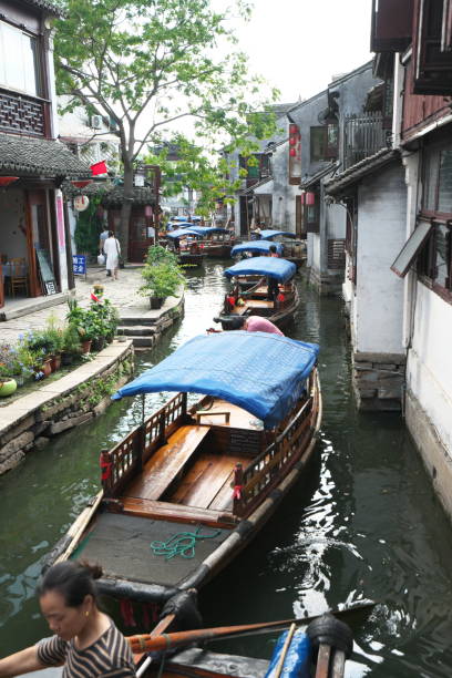 Boats in Zhouzhuang passing through canal Zhouzhuang,China-September 17, 2019: Boats in Zhouzhuang passing through canal suzhou creek stock pictures, royalty-free photos & images