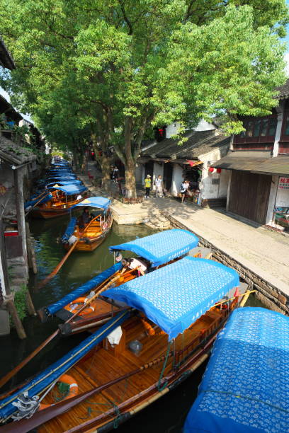 Boats in Zhouzhuang passing through canal Zhouzhuang,China-September 17, 2019: Boats in Zhouzhuang passing through canal suzhou creek stock pictures, royalty-free photos & images