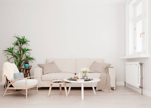 istock Mock up wall with beige white sofa, two tables and a chair in modern interior background, living room with large window an radiator, Scandinavian style, 3D render, 3D illustration 1176212670