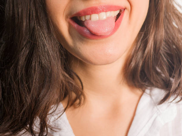 woman's tongue teeth lips close-up detail photo stock photo
