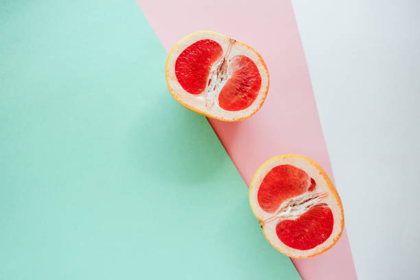 istock Half grapefruit citrus fruit on colorful background. Closeup view, flat lay 1176219077
