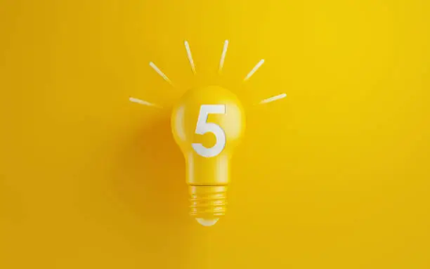 Photo of Light Bulb with Number Five on Yellow Background
