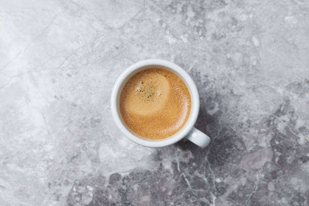 istock Cup of coffee on bright stone background. Top view. Copy space 1176228264