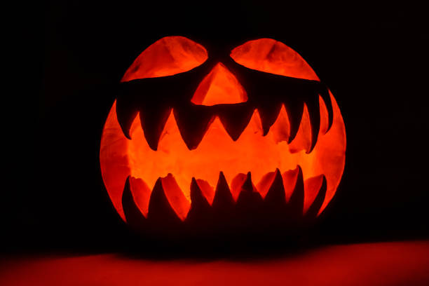 istock Spooky halloween pumpkin on a black background 1176228519