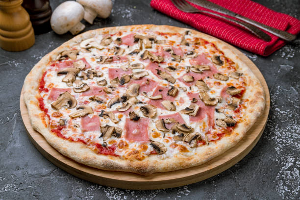 istock Pizza with ham and mushrooms on grey concrete table 1176230604