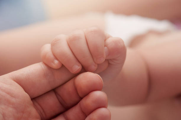 istock Baby hold mom finger 1176232619