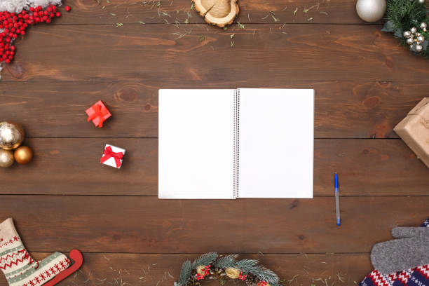 istock New Year. Opened notebook pen and gifts isolated on table top view close-up 1176237549