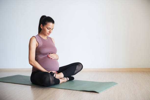 istock Pregnant woman doing pilates on an exercise mat 1176237801