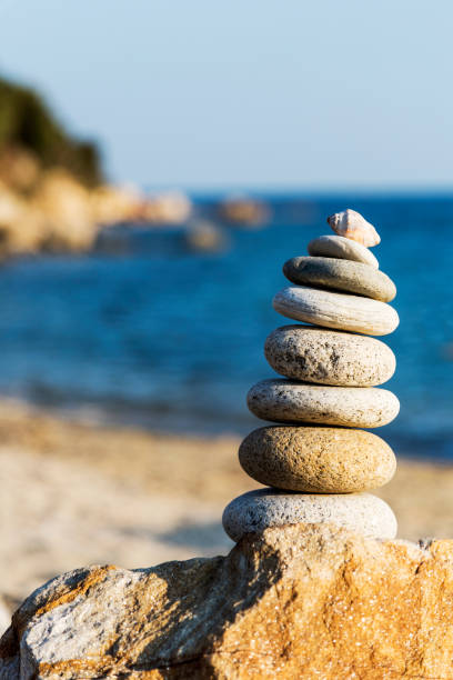 stones pyramid on beach in greece - aspirations pebble balance stack imagens e fotografias de stock