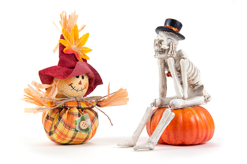 Scarecrow and skeleton sitting and waiting for Halloween