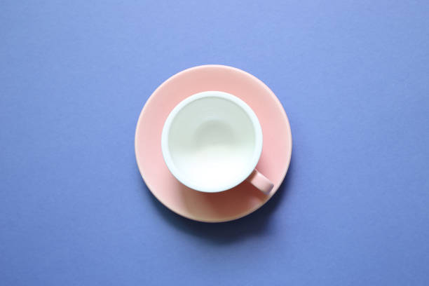 istock Pink coffee cup on purple background 1176247983