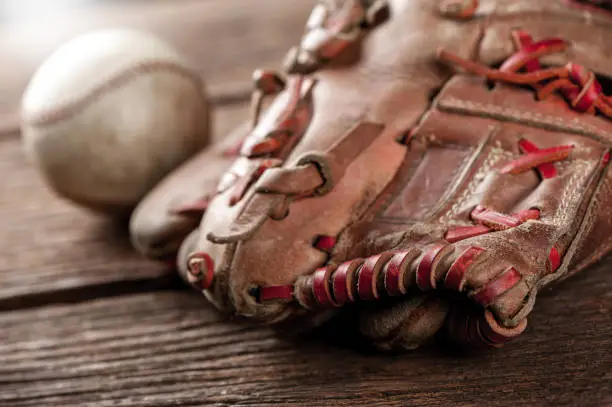 abstract old vintage baseball glove with baseball (Shallow depth of field)
