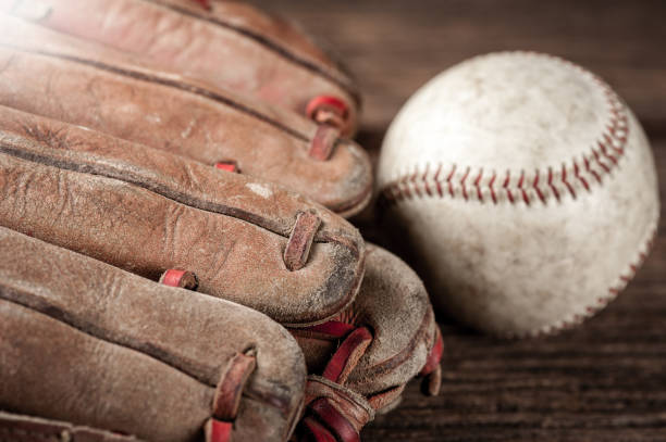 istock baseball on wooden desk 1176248812