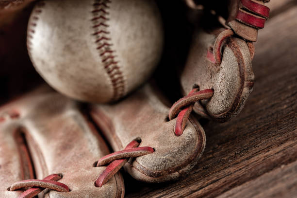 istock baseball on wooden desk 1176248823