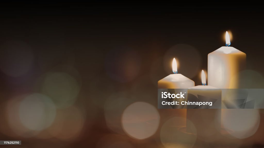 Christmas advent candle light in church with blurry golden bokeh for religious ritual or spiritual zen meditation, peaceful mind and soul, or funeral ceremony Funeral Stock Photo
